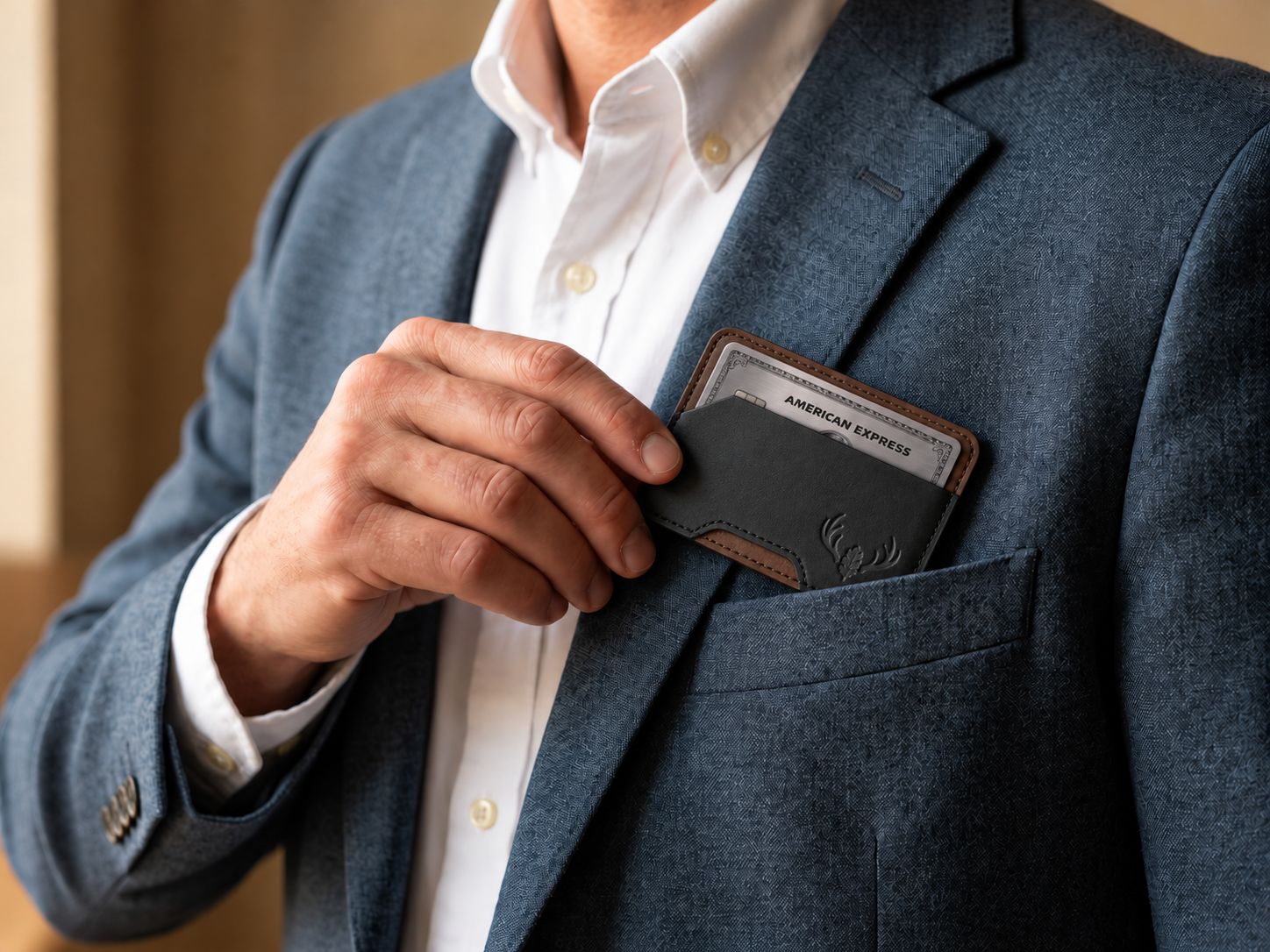 Man placing the compact Black and Walnut OB-03 minimalist card wallet into a tailored jacket pocket