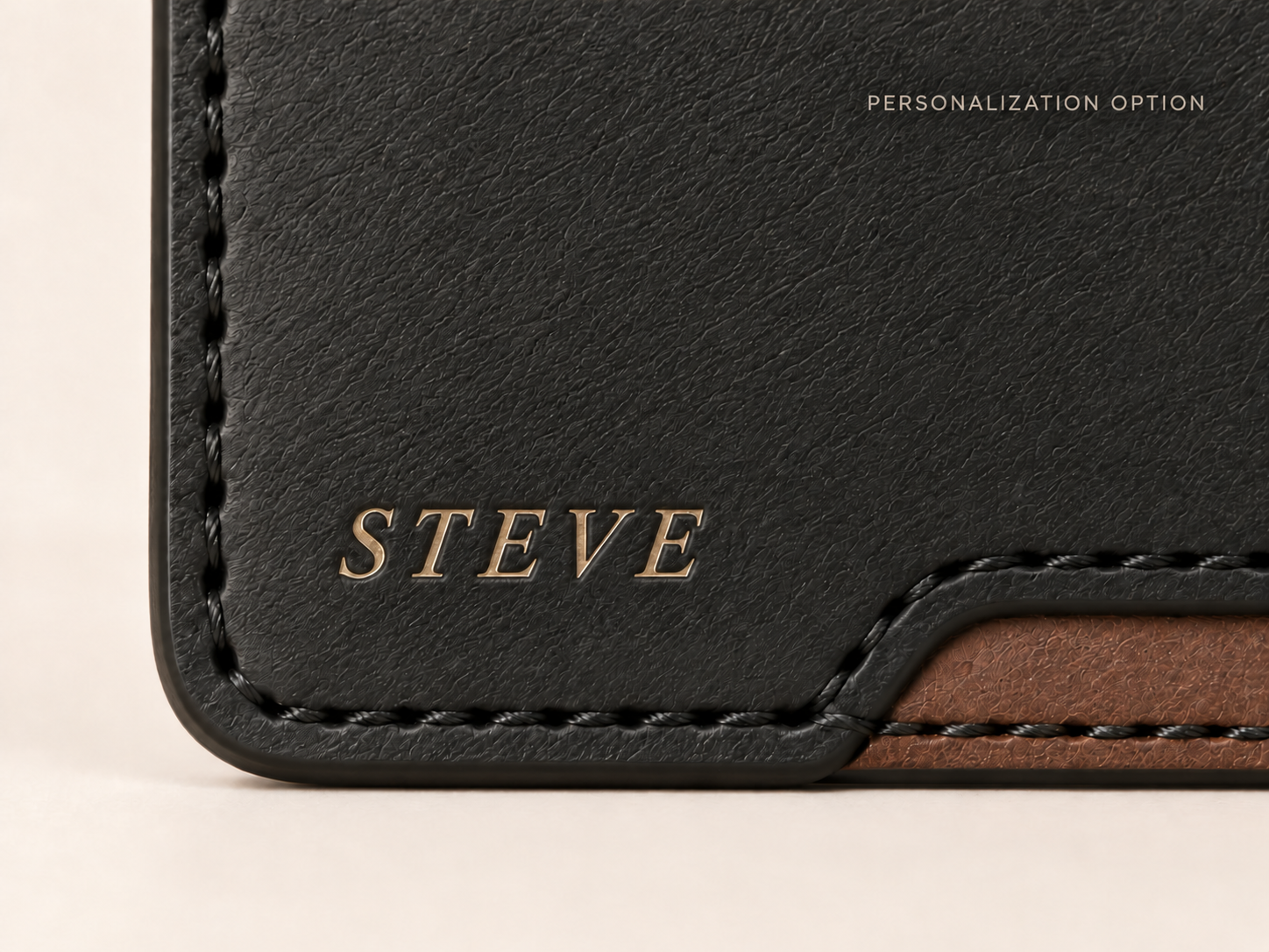 Close-up of the OB-03 wallet personalized with STEVE in matte-gold debossed lettering
