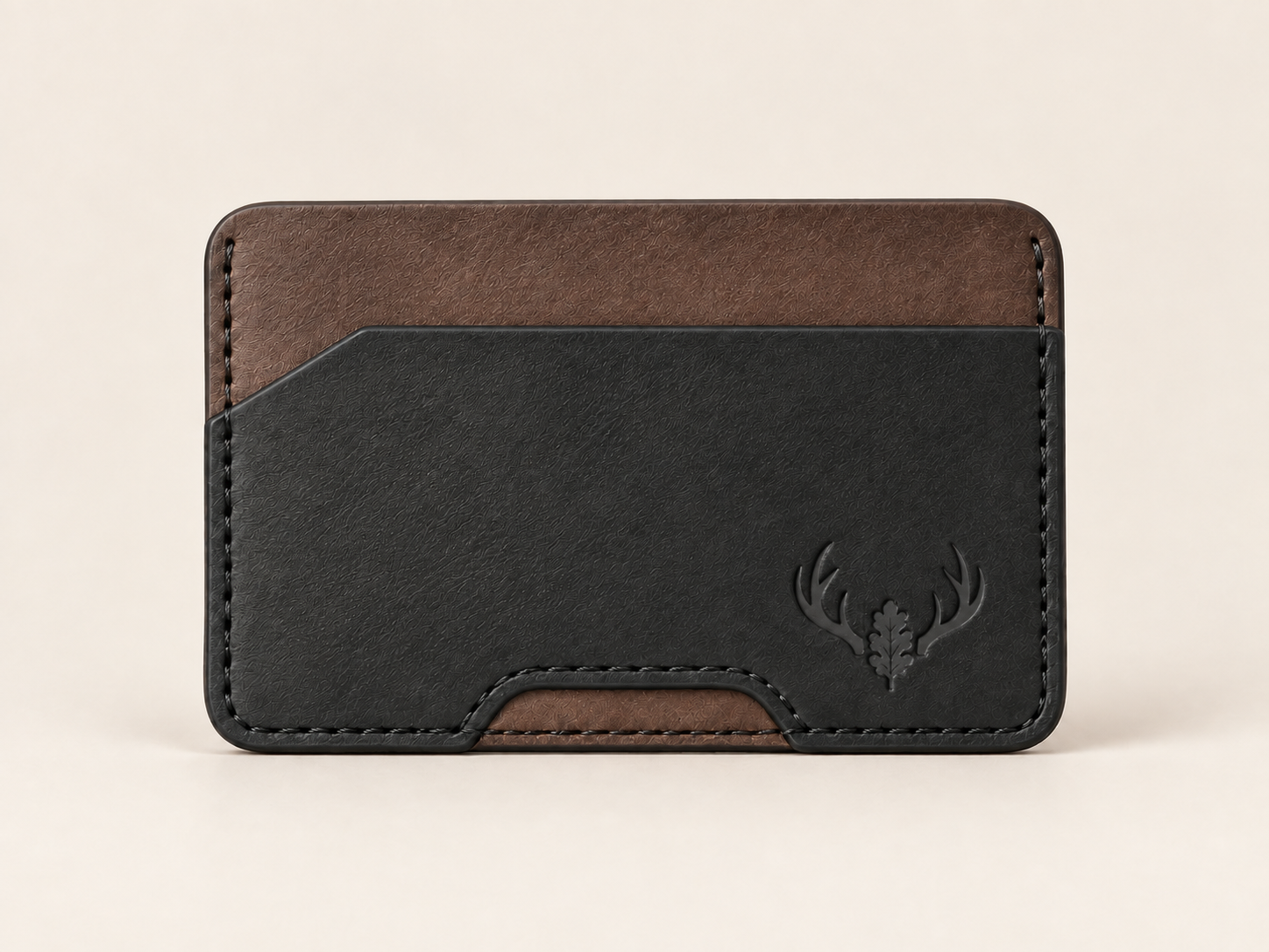 Front view of the black and walnut OB-03 minimalist card wallet on an off-white background